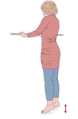 This illustration shows a rear view of a woman doing calf raises to strengthen her calf muscles
